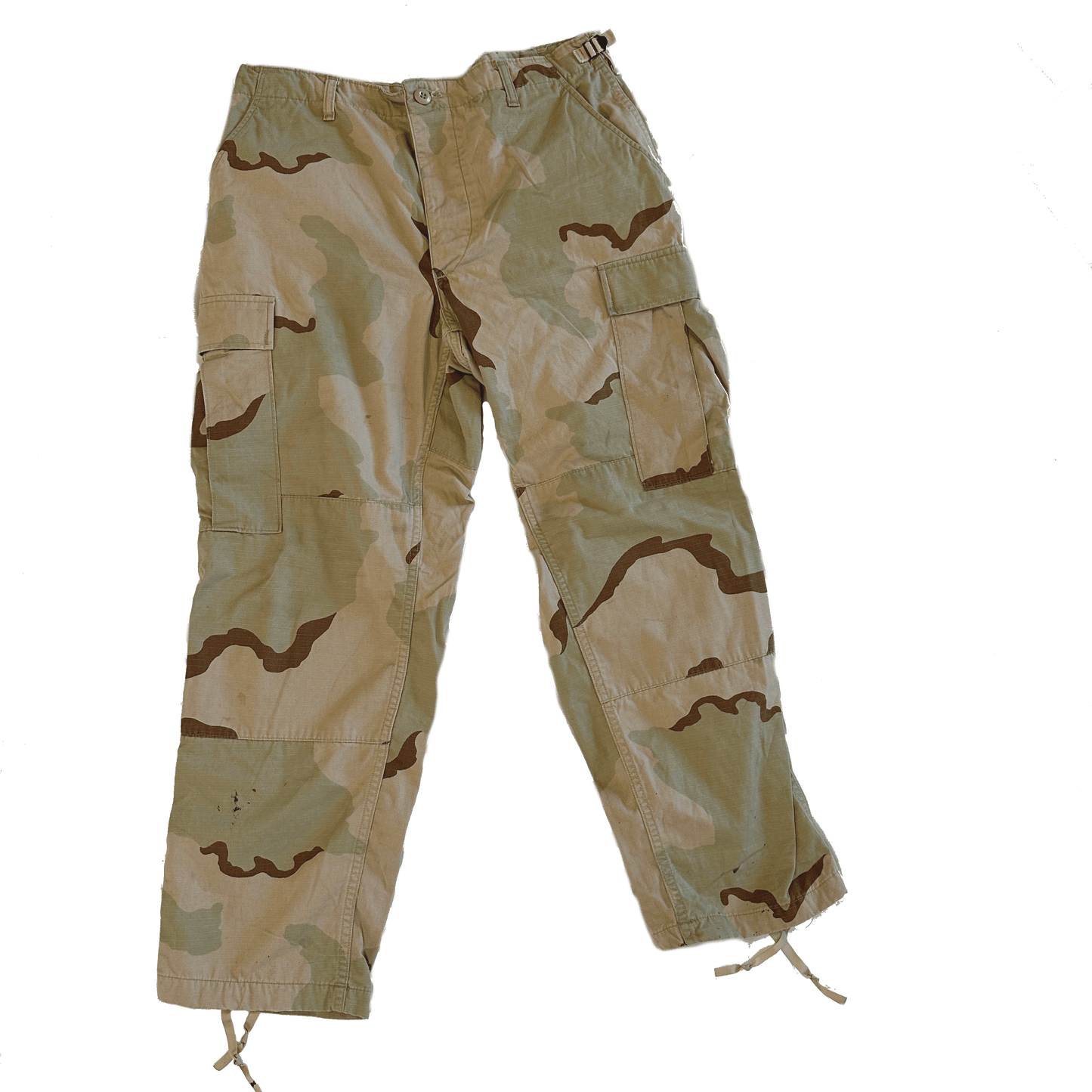The image features Six Gun Surplus "DCU Tri-Color Desert Camo Pants" in a beige color scheme, equipped with multiple pockets and drawstrings at the ankles, ideal for military or outdoor use. The pants are set against a black background.