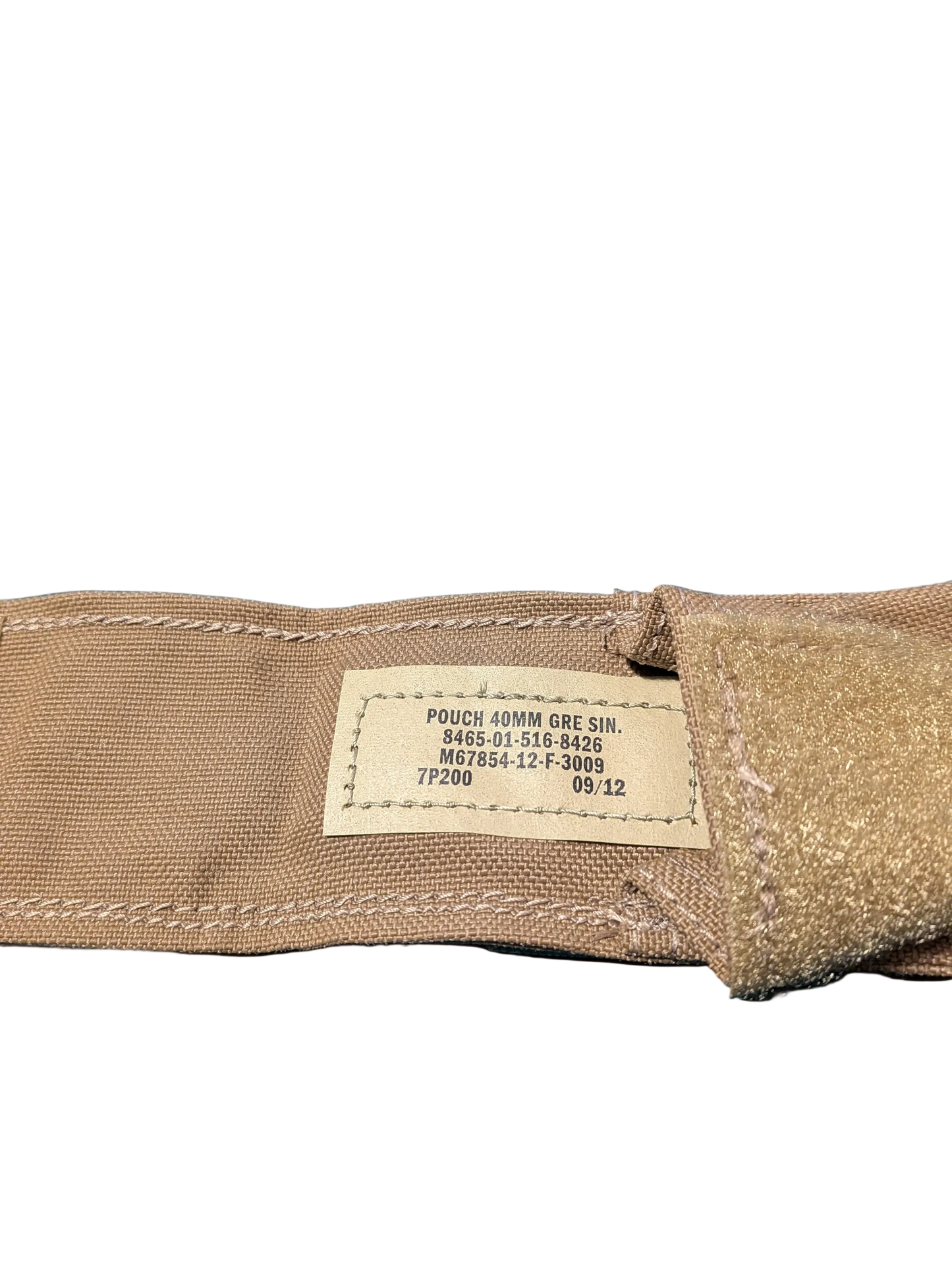 Close-up of a brown fabric pouch with a label on a black background