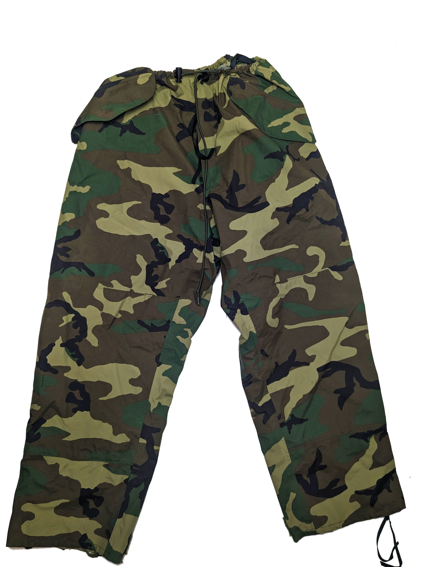 A pair of U.S. Issue ECWCS Woodland Gore-Tex Pants from Six Gun Surplus, designed with a drawstring waist and crafted from military-grade materials. These pants feature a green, brown, beige, and black camouflage pattern typical of military styles. They are laid out flat against a solid black background, highlighting their rugged texture.