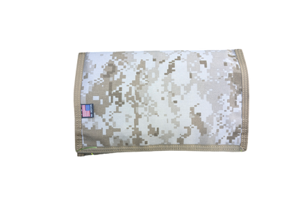 The Six Gun Surplus Map Case "RECCE pouch," featuring a beige and brown camouflage pattern with a small American flag tag, is displayed against a black background. This rectangular pouch includes a neatly stitched flap folded over the front, making it perfect for adventurous gear.