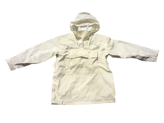 The Six Gun Surplus French Army Alpine Snow Camo Parka is a white, long-sleeve pullover featuring a hood and a spacious front pocket. Crafted from lightweight material, it includes drawstrings at the hood and offers a loose fit that extends to mid-thigh length. The wide sleeves highlight its relaxed design, making it ideal for winter conditions.