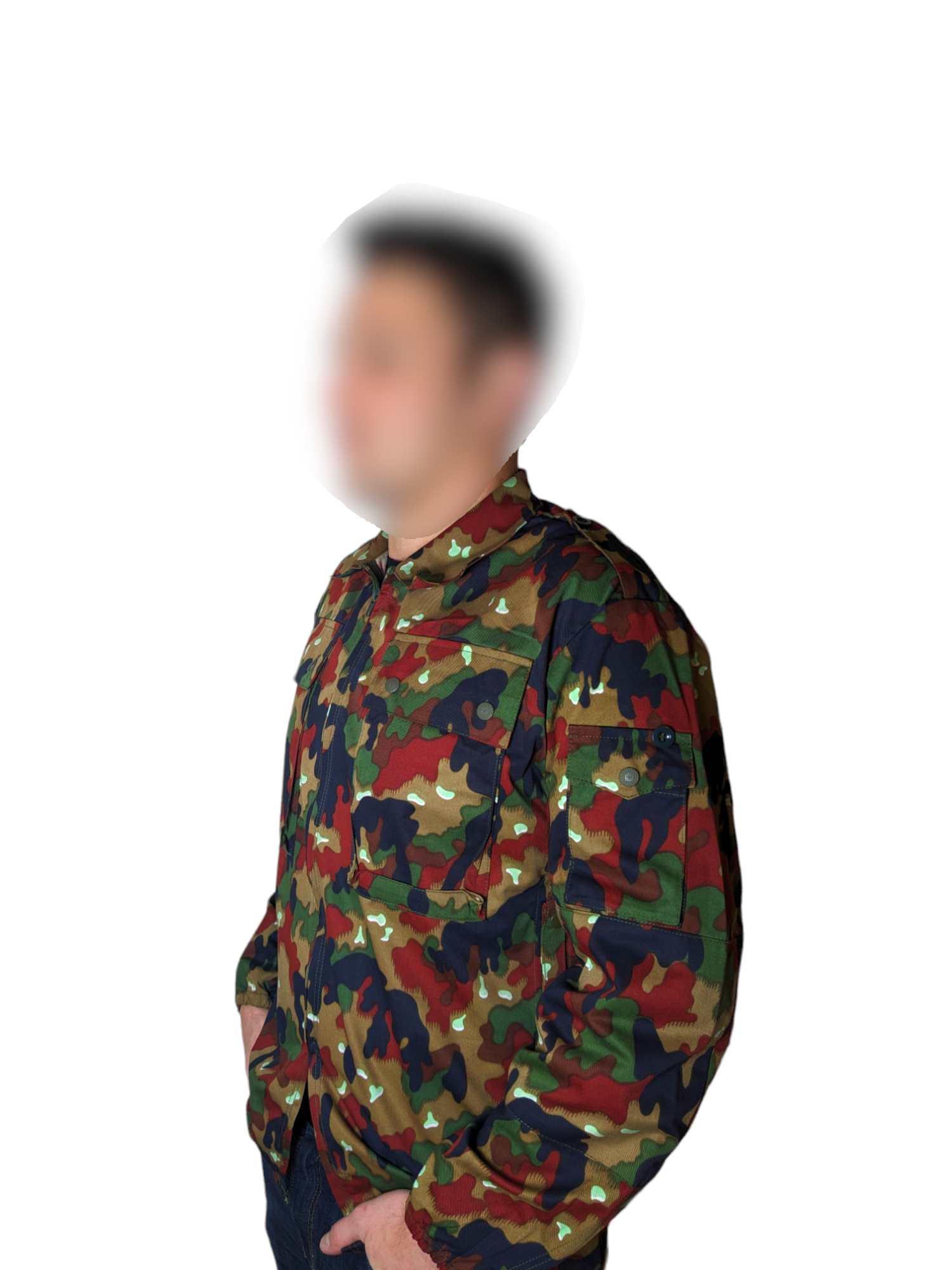 A person wearing a durable Six Gun Surplus Swiss M83 Camo Field Shirt with hands in pockets is standing against a white background. The face is blurred, making the person unidentifiable. The functional jacket features a combination of green, brown, and beige patterns.