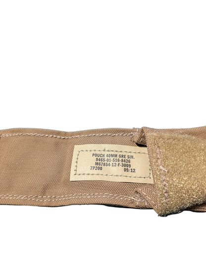 Close-up of a brown fabric pouch with a label on a black background