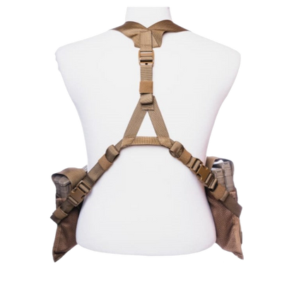 The Unissued US Marine Corps TAP Chest Rig Kit by Six Gun Surplus is displayed on a white mannequin torso. This tan tactical harness features multiple adjustable straps and buckles, with MOLLE pouches attached on both sides. The photo is taken from the back view, showcasing the structure and design of this low-profile platform.