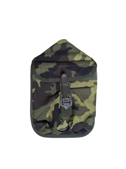 A camouflage-patterned pouch with a flap secured by a buckle on a black background. The pouch, designed in green, brown, and black shades typical of military camo, serves as a Czech M95 Camo MOLLE Shovel Cover from Six Gun Surplus.